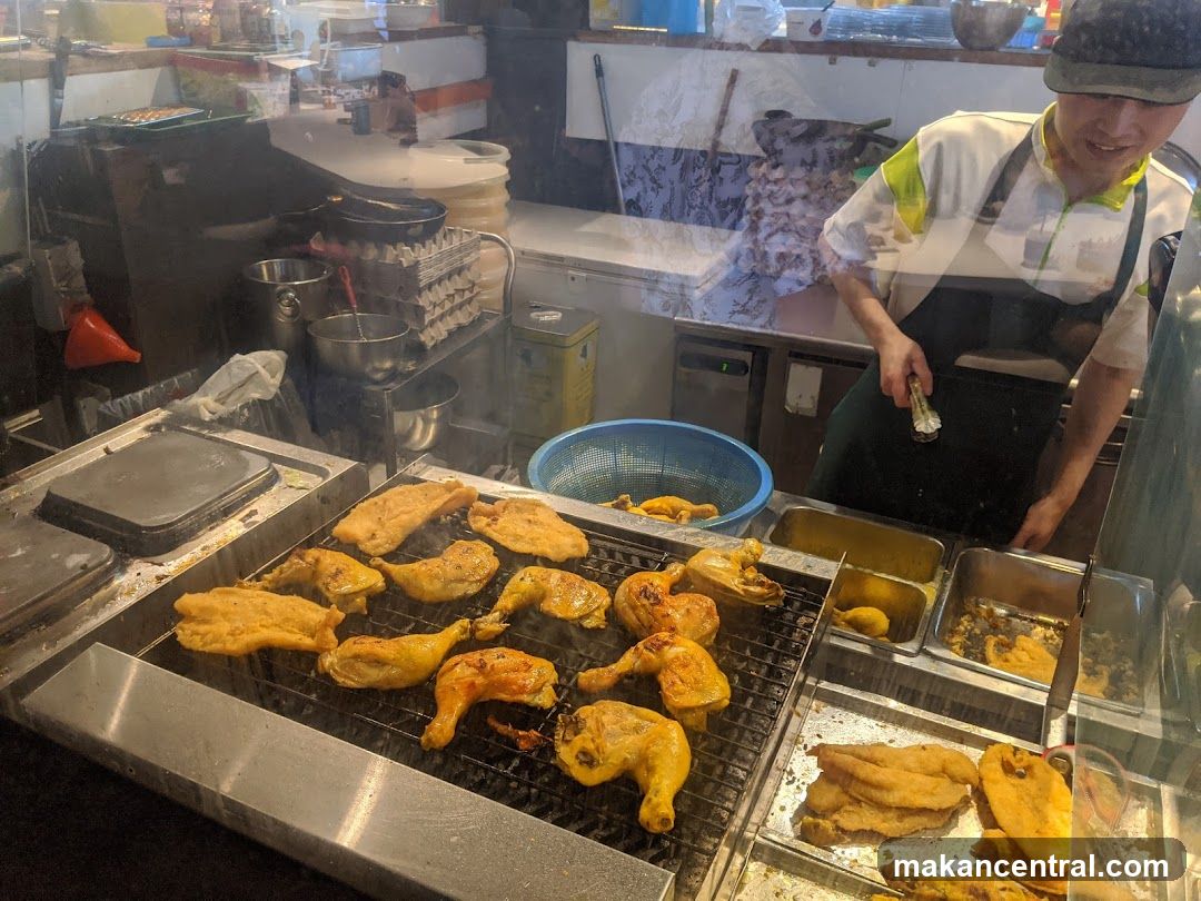 Food Stall with Grilled Chicken and Fish