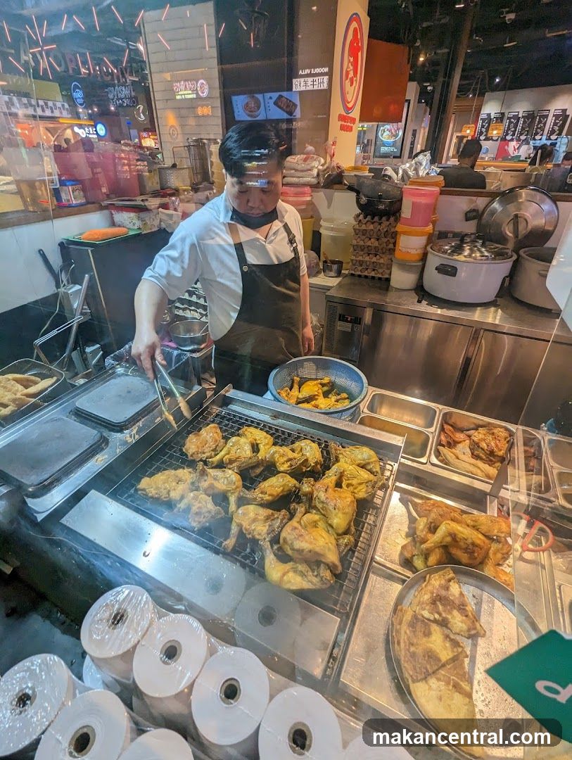 Cook preparing grilled chicken