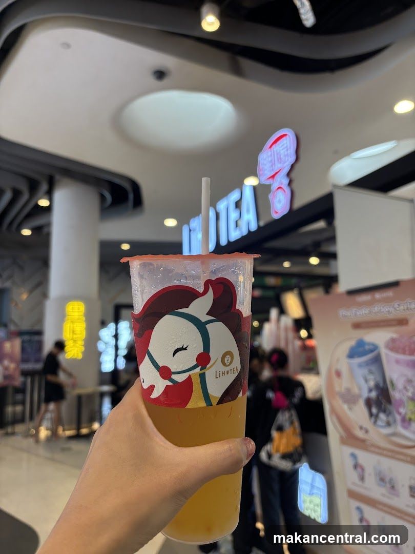 Hand holding a drink with a logo
