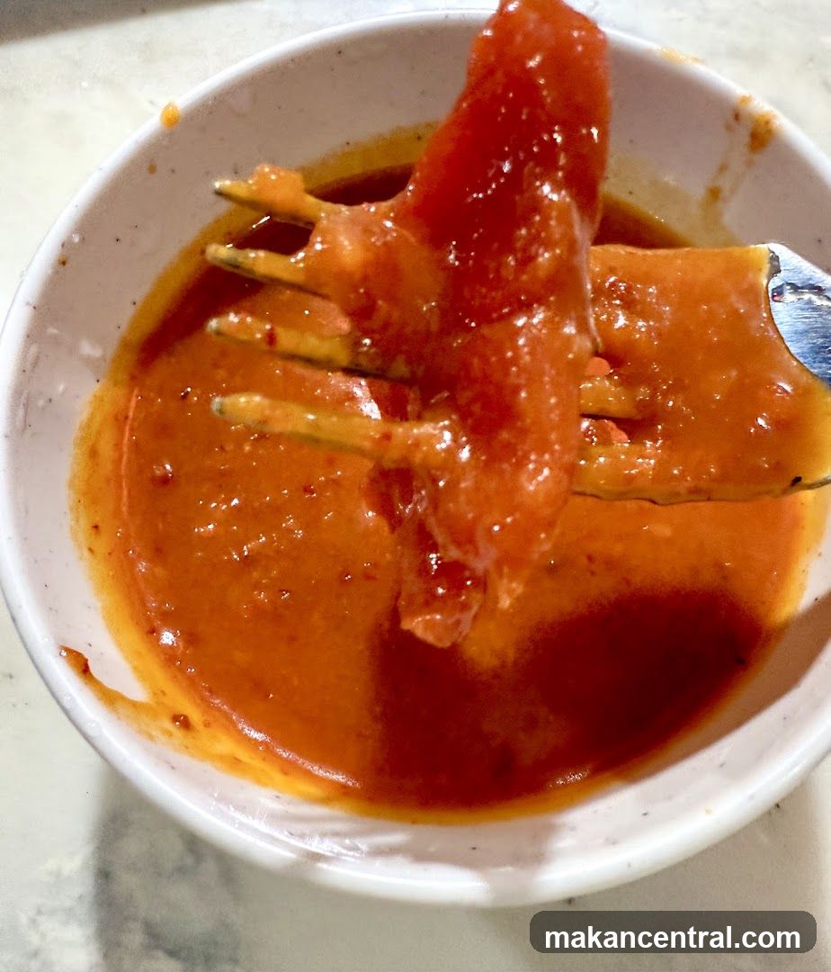 Food on Fork Dipped in Sauce