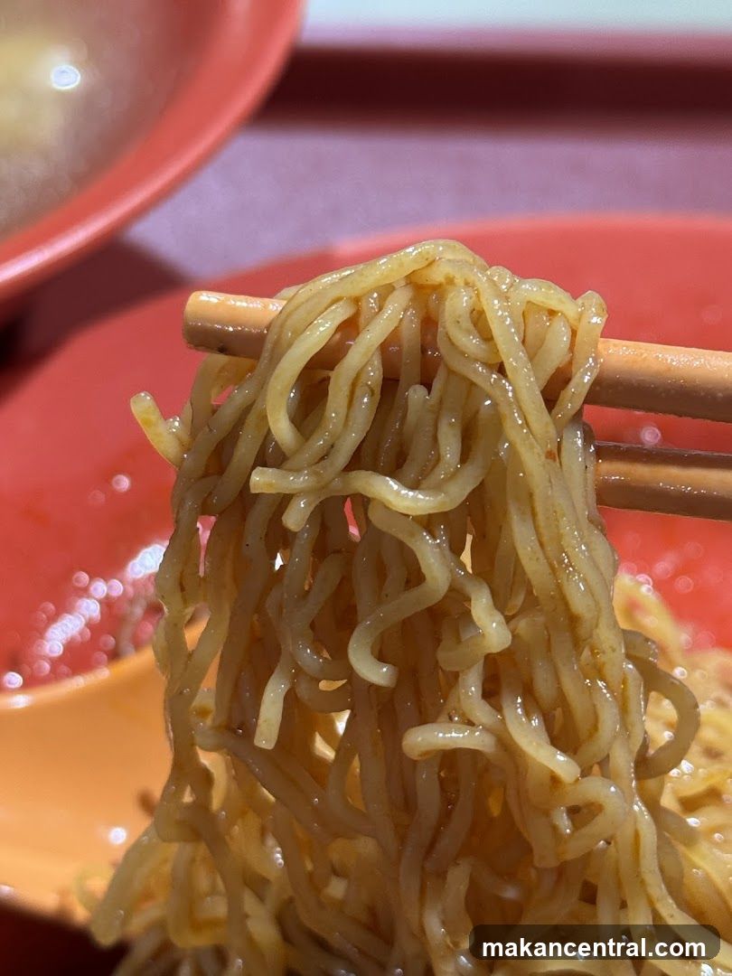 Noodles being lifted with chopsticks