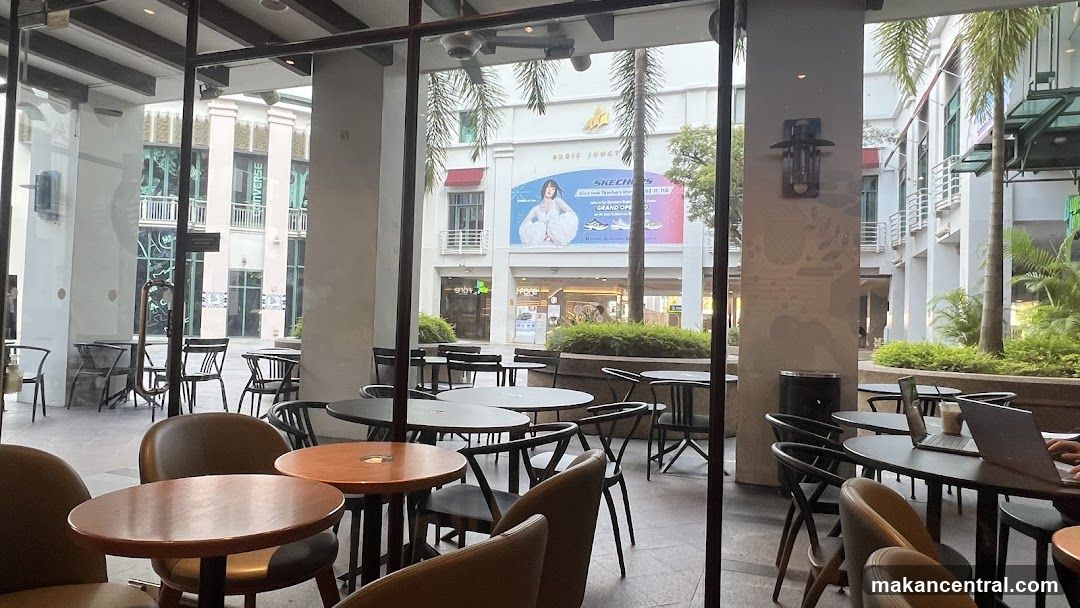Outdoor Seating Area with Shops in Background