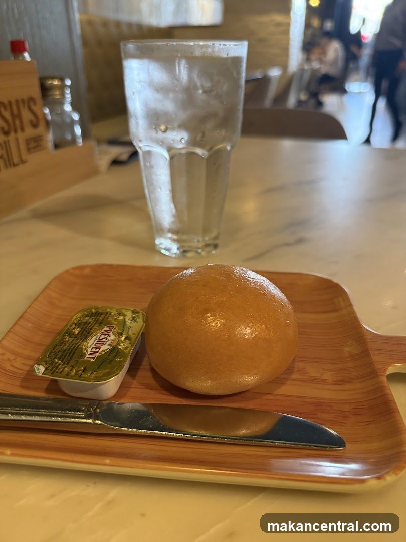 Bread roll with butter and water