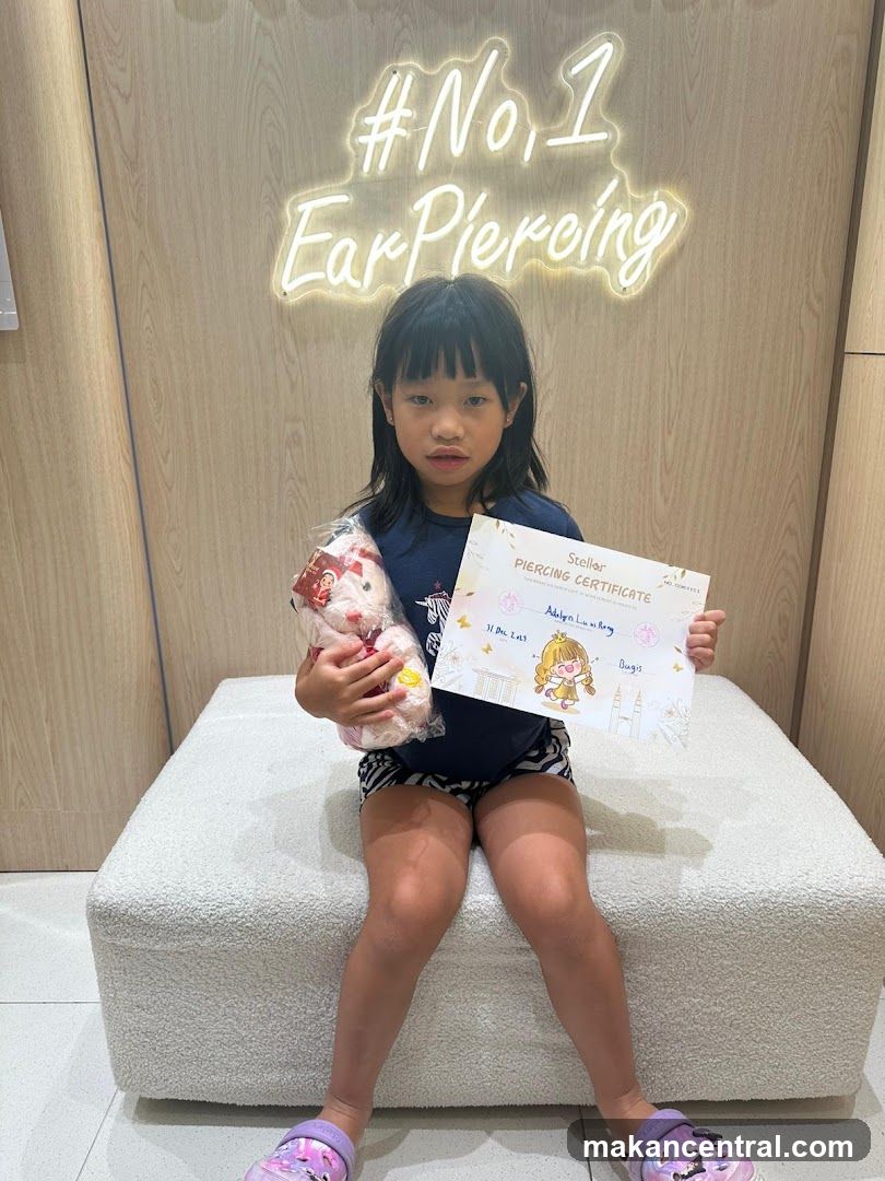 Girl Holding a Piercing Certificate and a Stuffed Toy
