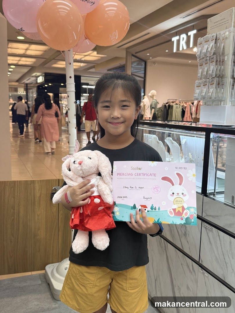 Girl Holding Piercing Certificate and Stuffed Animal