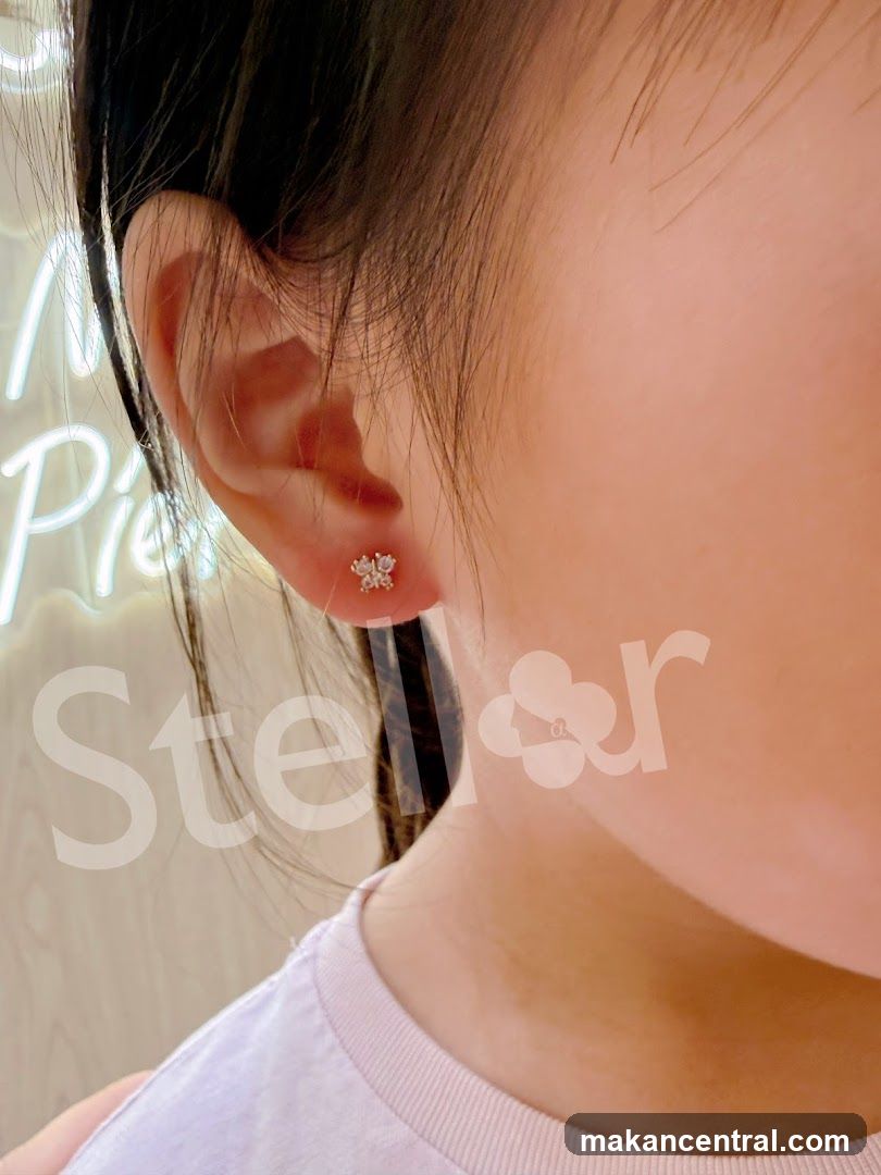 Close-up of a person's ear with a small, delicate stud earring.