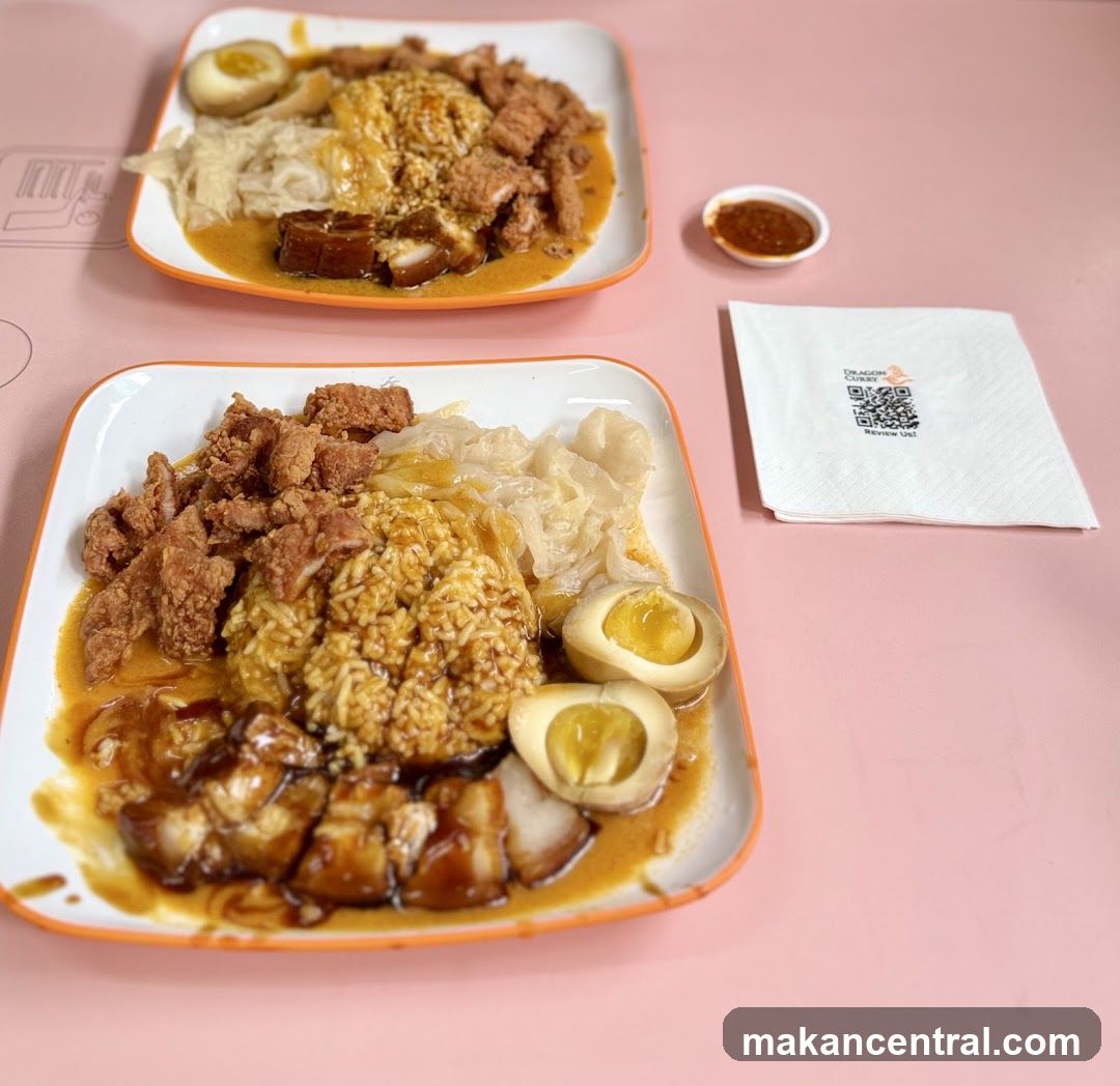 Two plates of curry rice with meat and eggs
