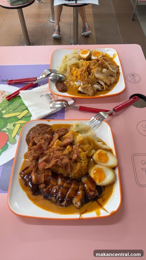 Two plates of rice with meat and eggs
