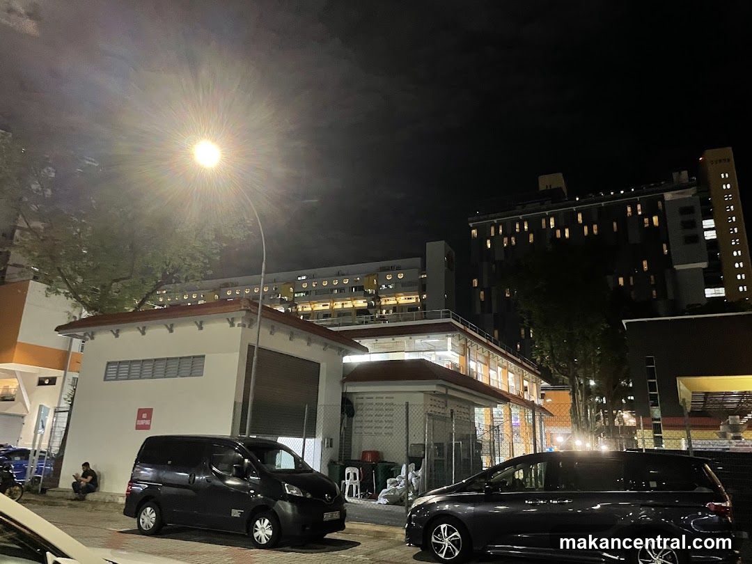 Nighttime street scene with buildings and vehicles