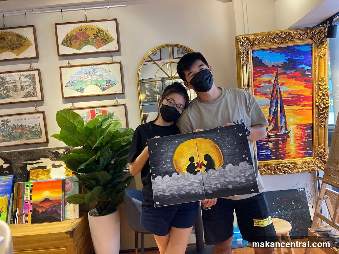 Couple holding a painting
