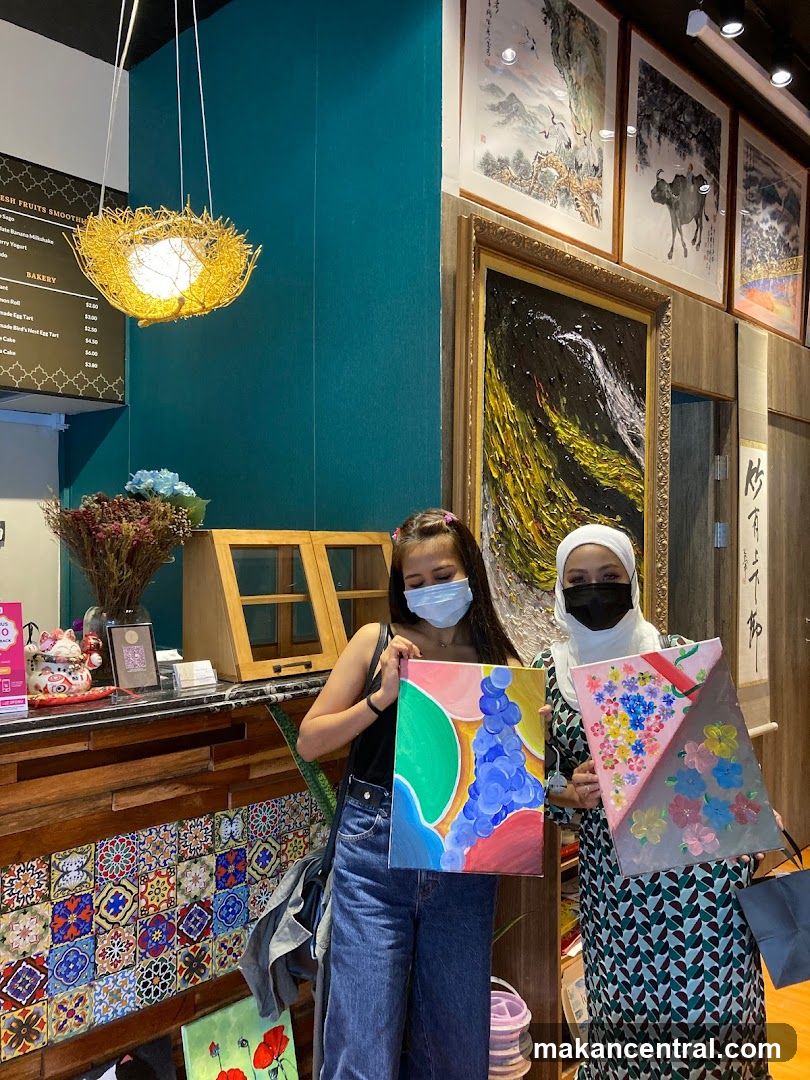 Two Women Holding Paintings