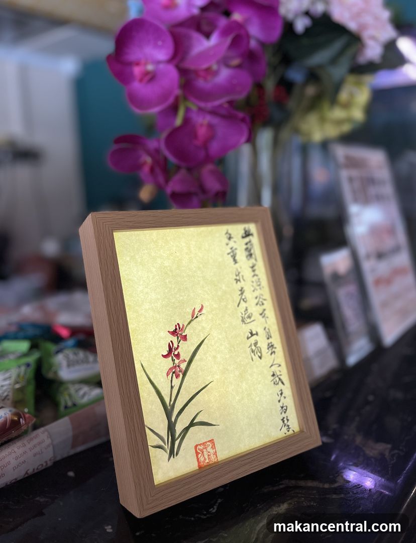Framed Artwork with Flowers and Calligraphy