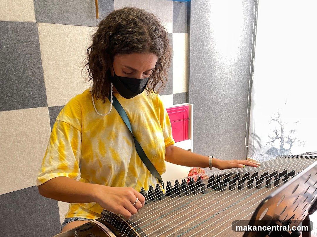Woman playing a zither