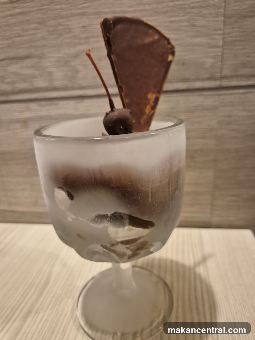Chocolate dessert with cherry and chocolate garnish