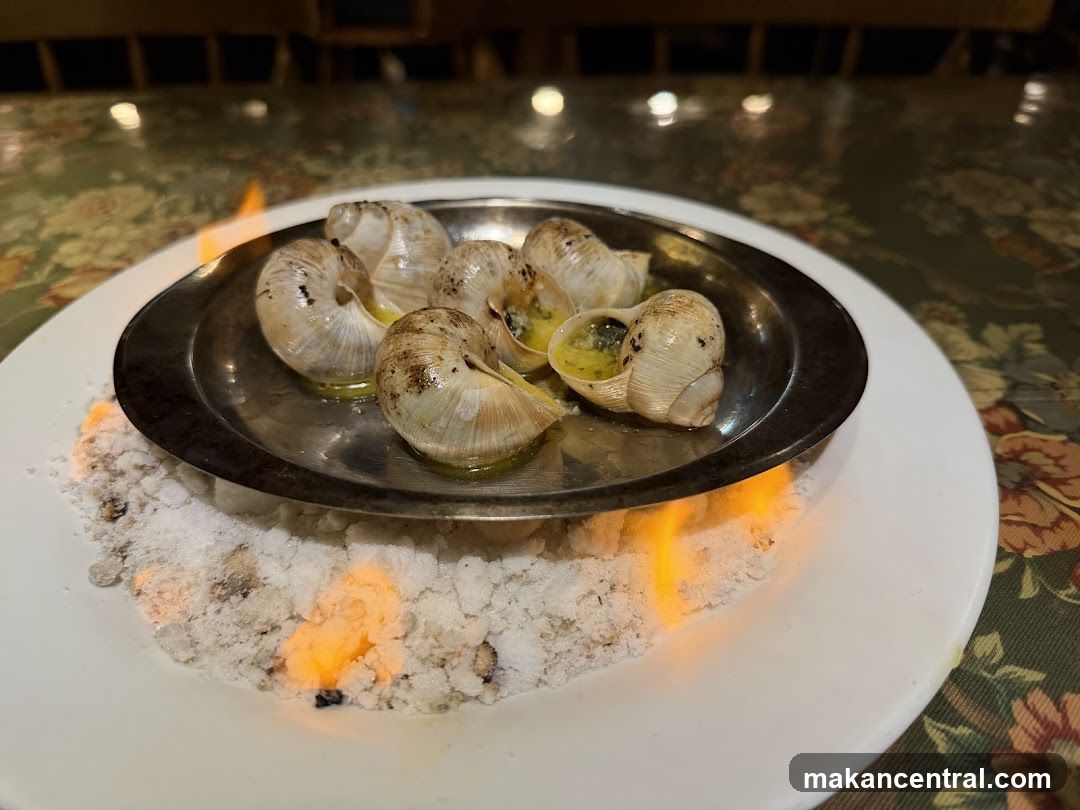 Escargots on a bed of salt with flames