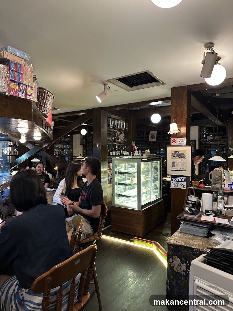 Interior of a cafe with patrons and display case