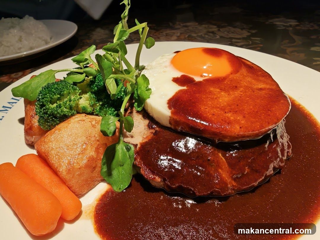 Hamburger steak with fried egg and vegetables