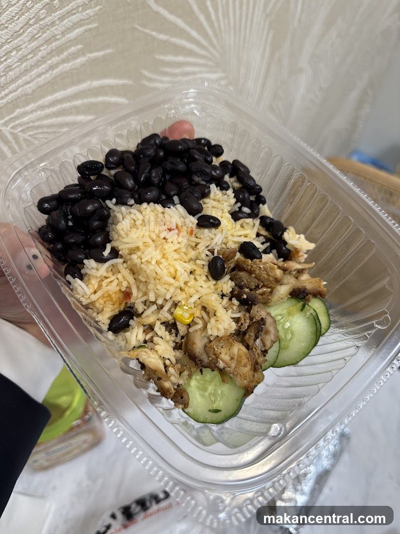 Rice bowl with chicken, beans, and cucumber