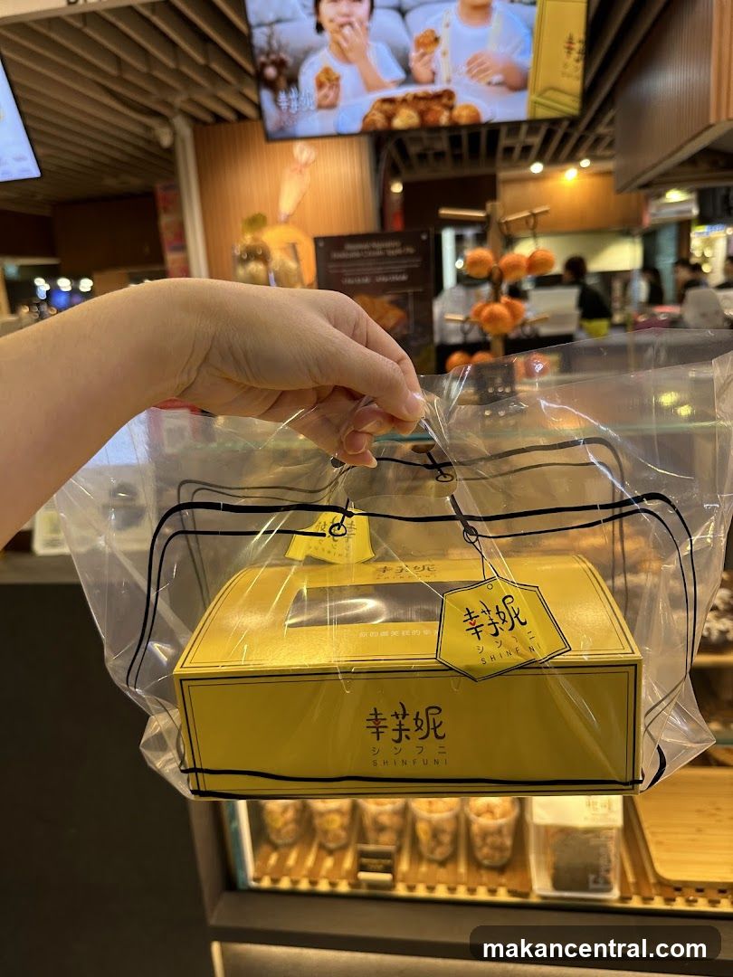 Hand holding a gift box from Shinfuni