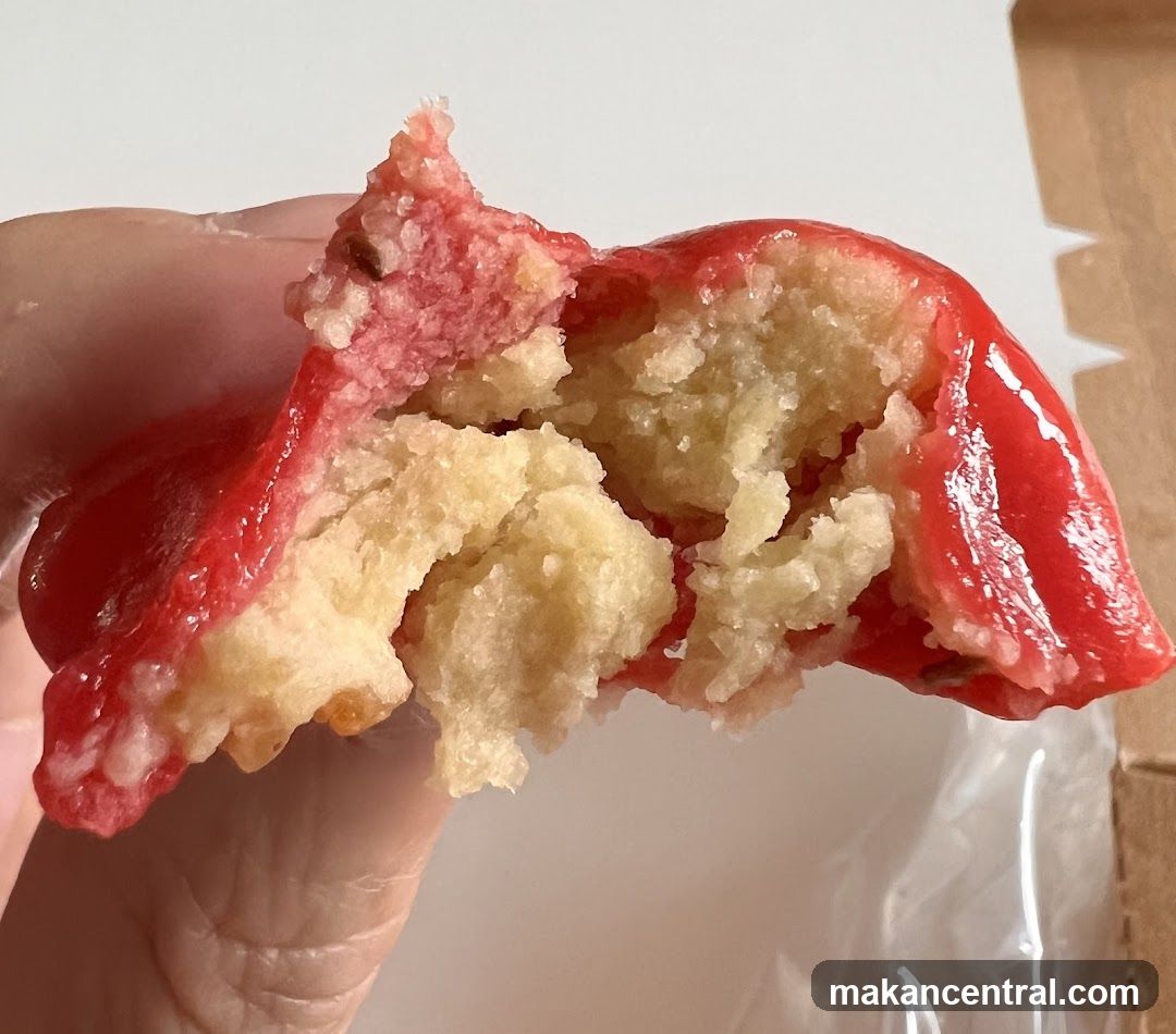 Close-up of a broken cookie with red icing