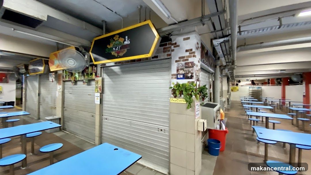 Food court with closed stalls and empty tables
