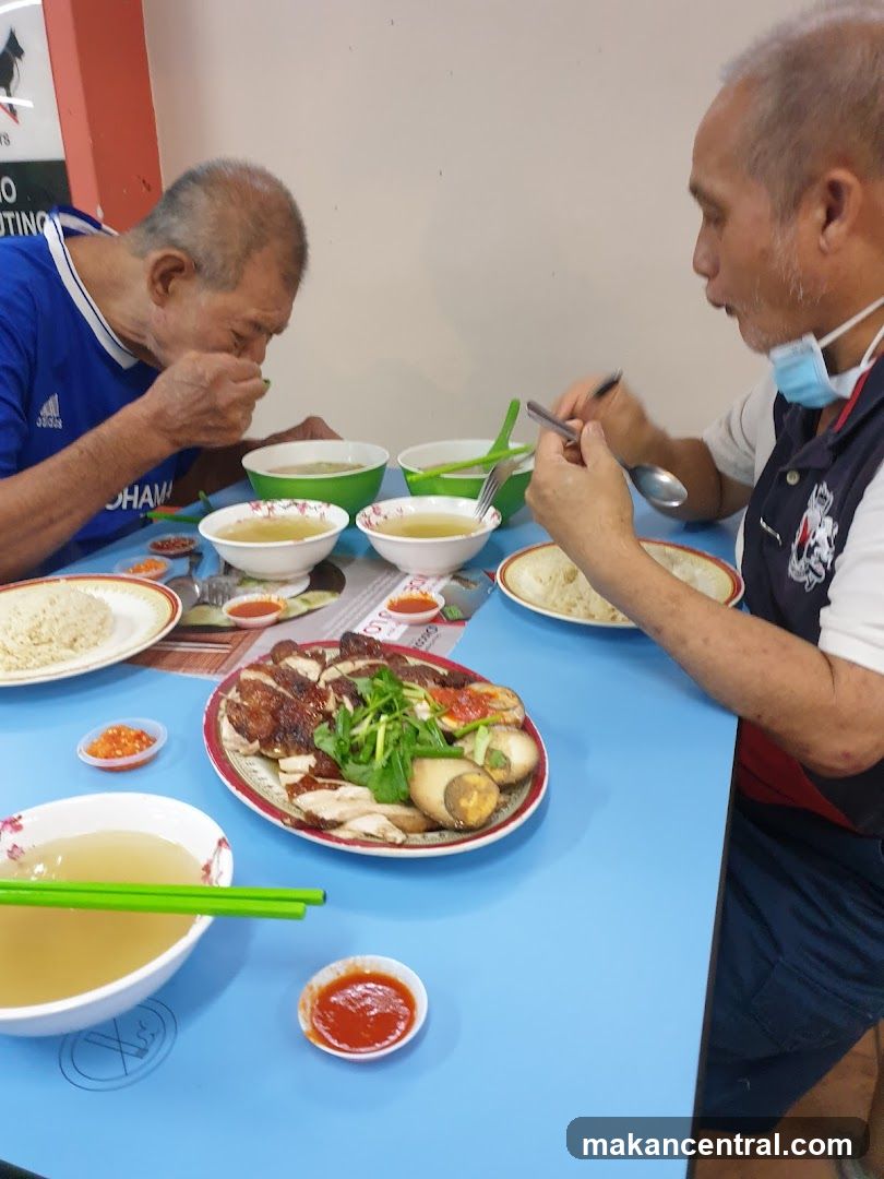 Two Men Eating Chicken Rice