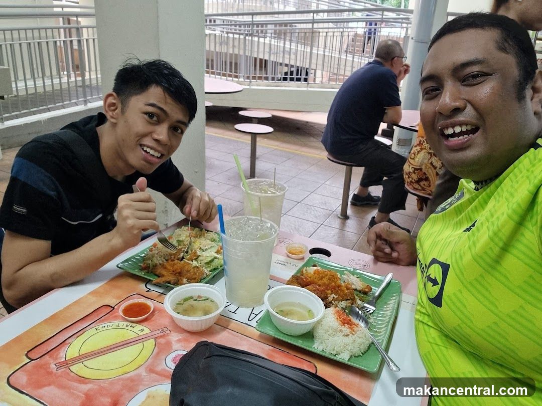 Two men enjoying a meal at a food court