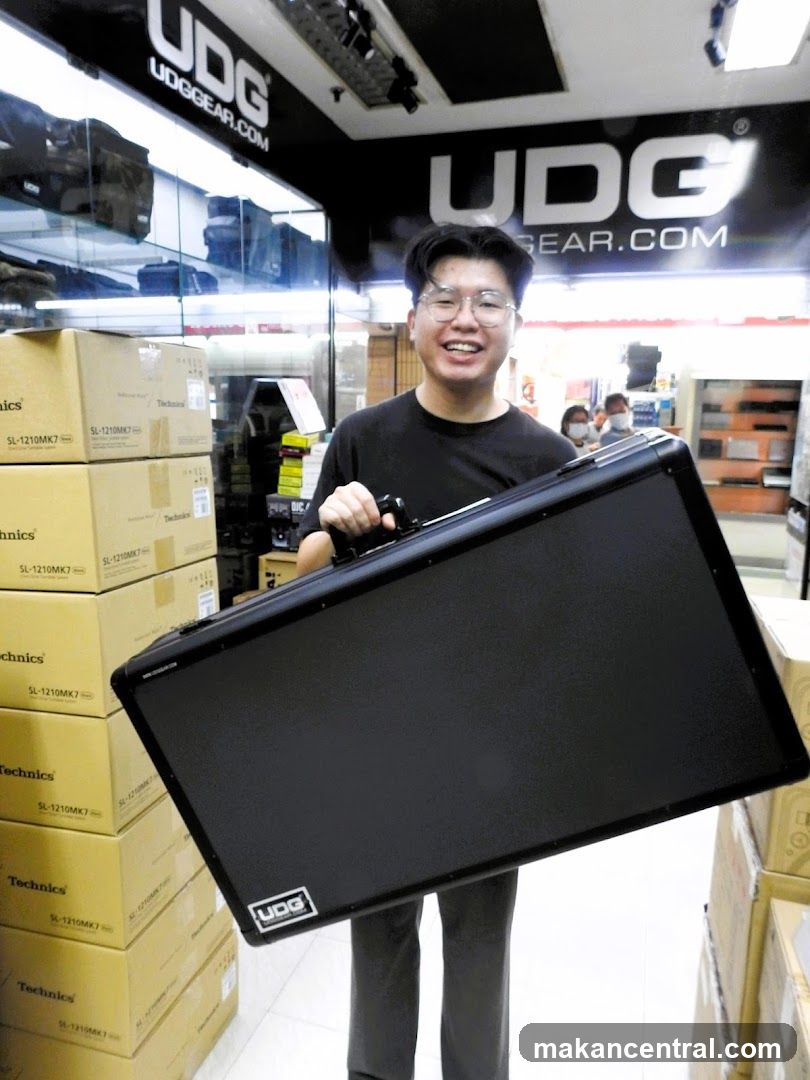 Man holding a black case in a store