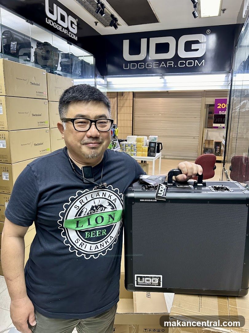 Man holding a UDG case in a store