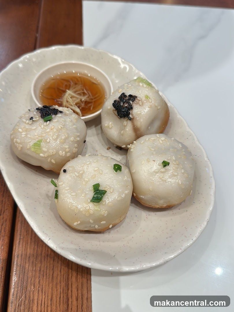 Pan-fried dumplings with dipping sauce