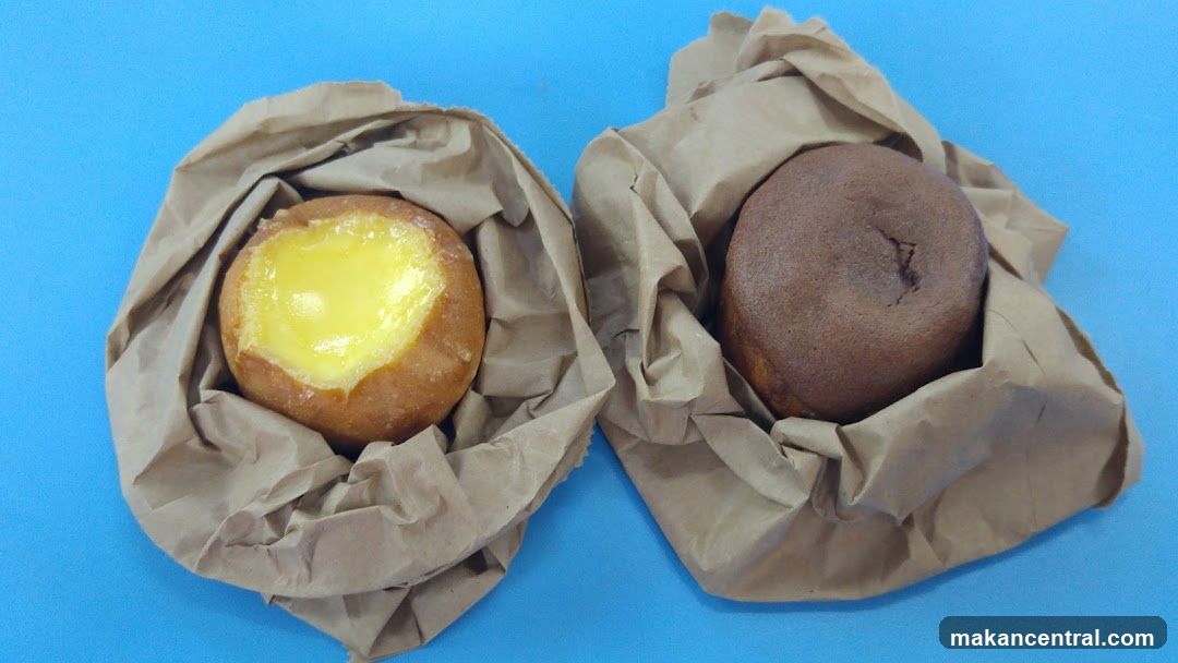Two pastries in paper bags