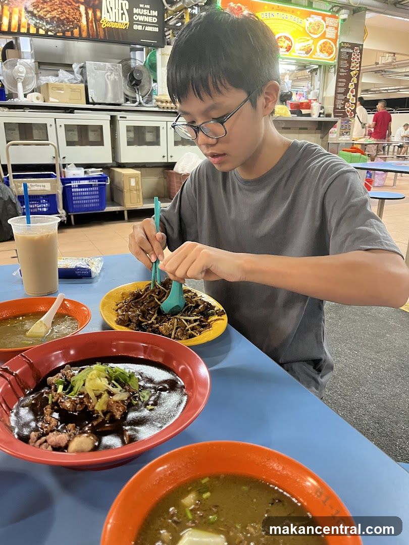 Boy eating noodles at a food stall