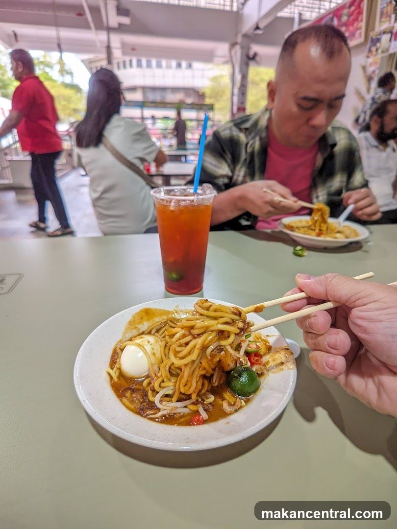 People eating noodles at a food court
