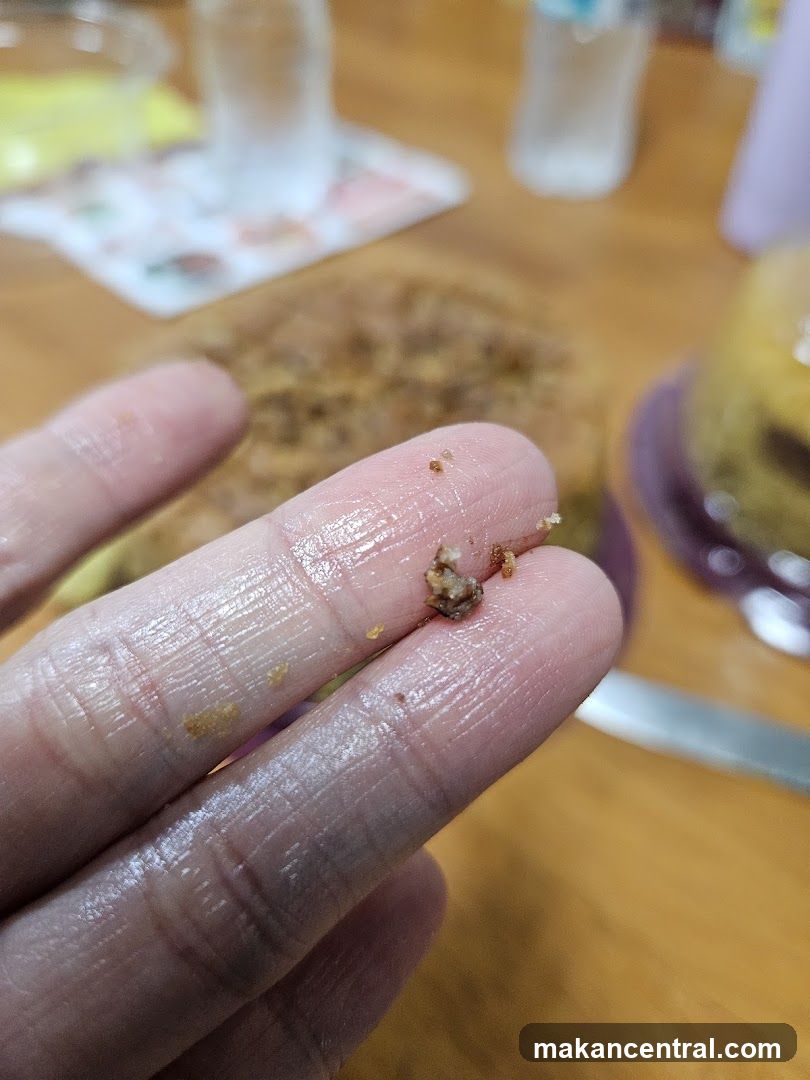 Close-up of crumbs on fingers
