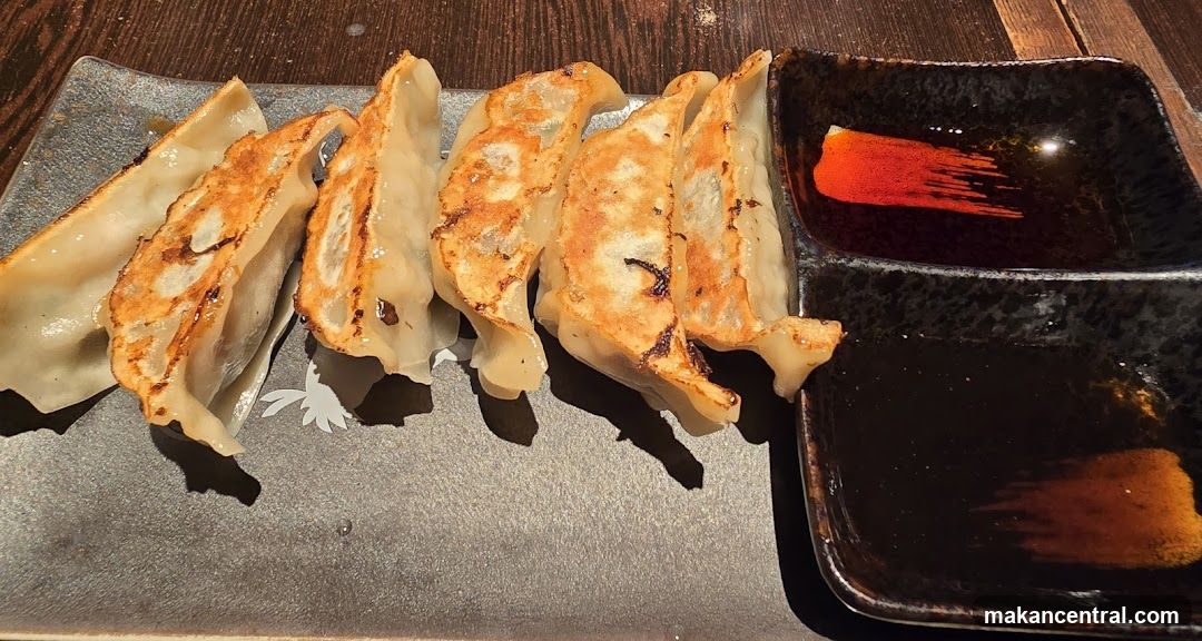 Pan-fried dumplings with dipping sauce