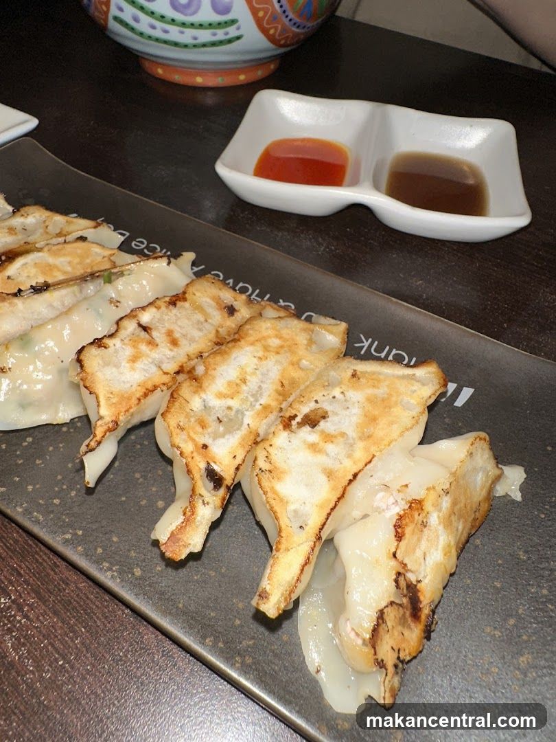 Pan-fried dumplings with dipping sauces