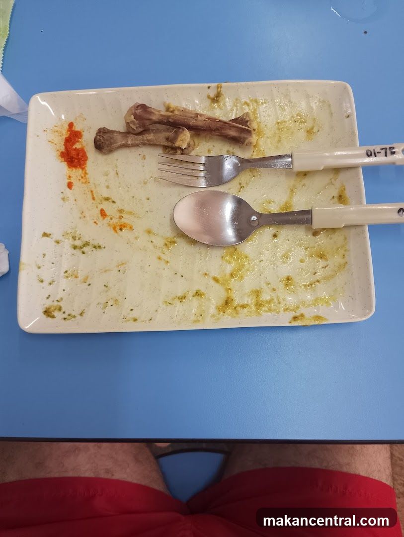 Dirty Plate with Bones and Utensils