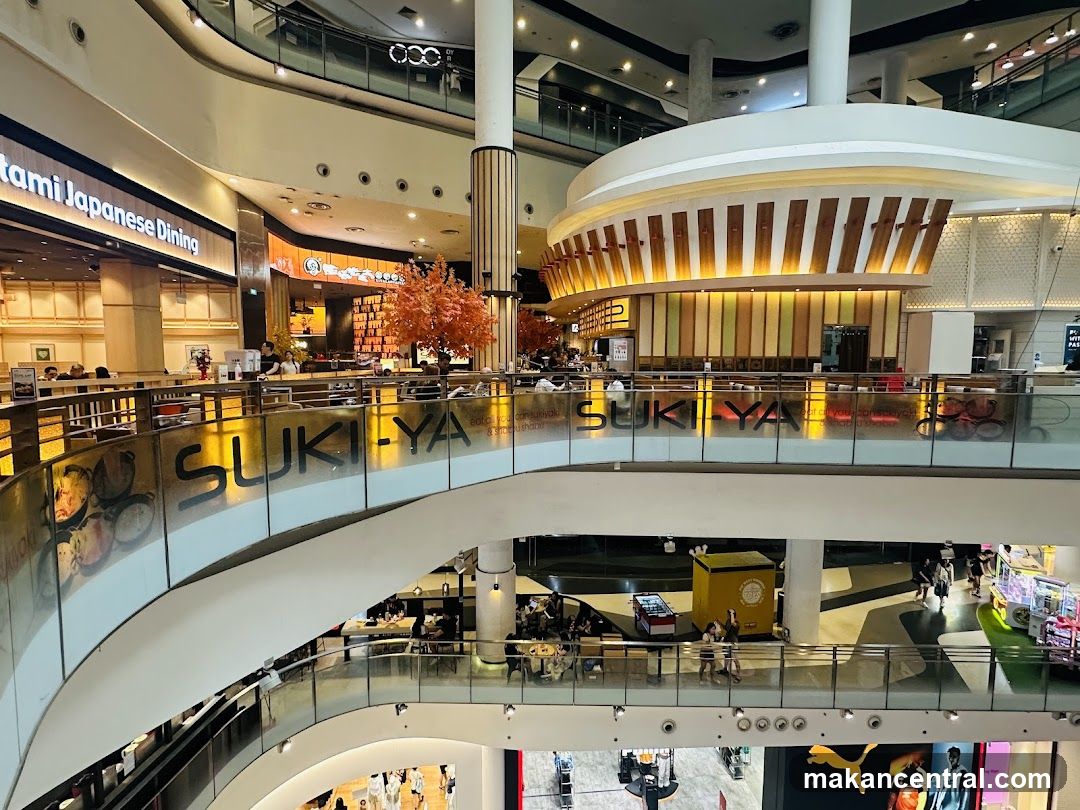 Multi-level shopping mall interior with restaurants and shops