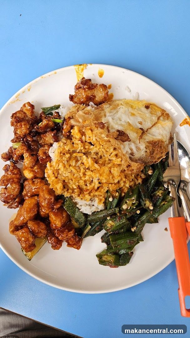 Plate of food with fried chicken, rice, and okra