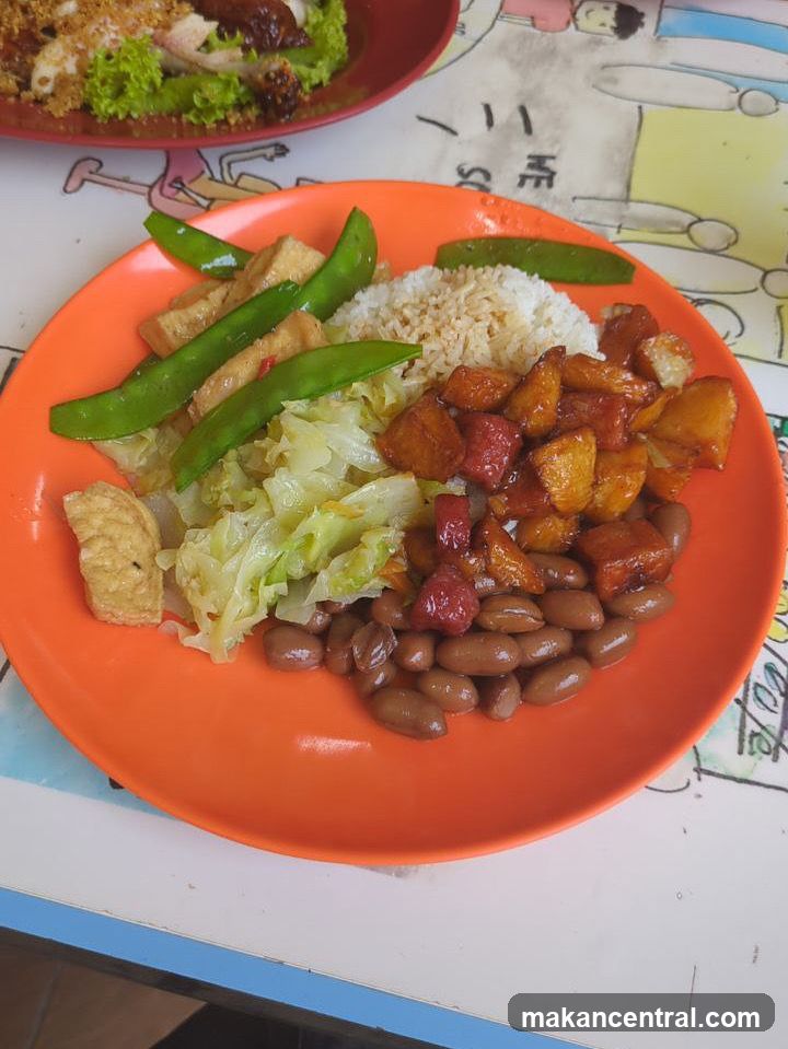 Plate of food with rice, beans, and vegetables