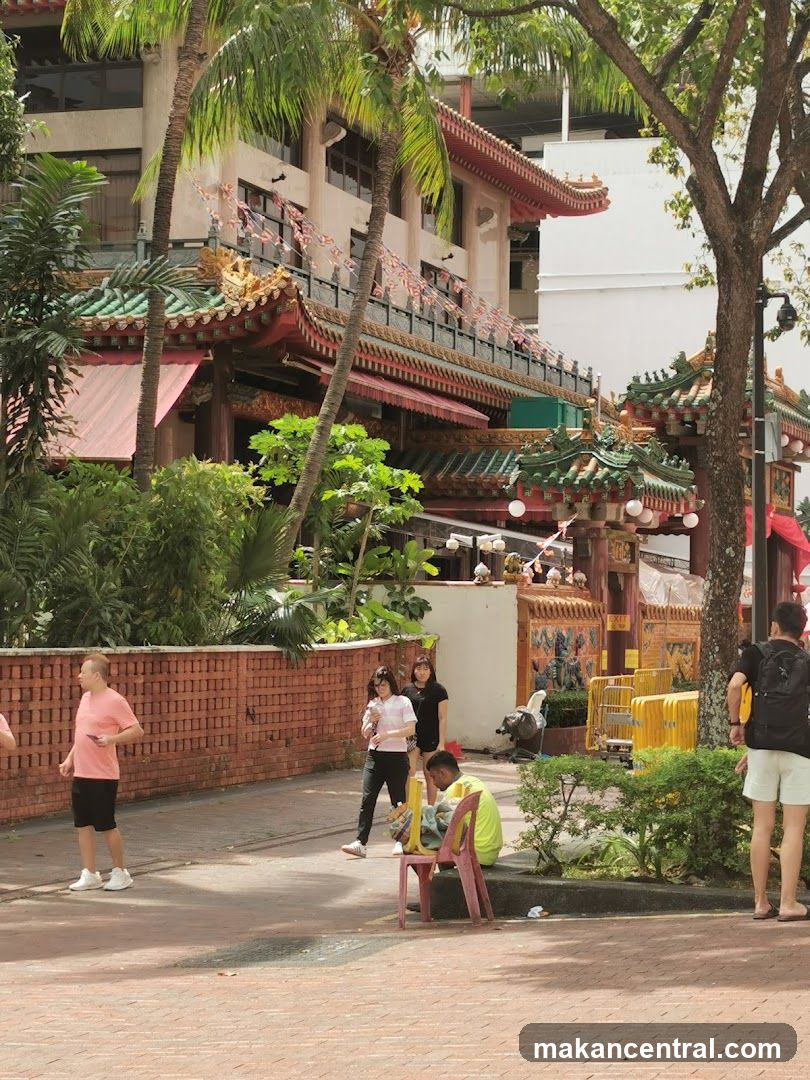 People walking past a temple entrance