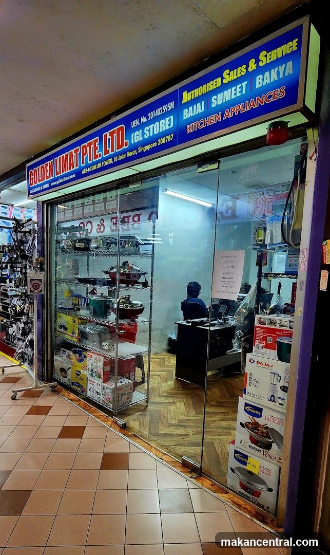 The storefront of Golden Limat Pte. Ltd., a store specializing in kitchen appliances. The sign above the entrance reads "GOLDEN LIMAT PTE. LTD. (GL STORE)" and "AUTHORISED SALES & SERVICE BAJAJ SUMEET BAKYA KITCHEN APPLIANCES". The store displays various kitchen appliances on shelves behind a glass door.