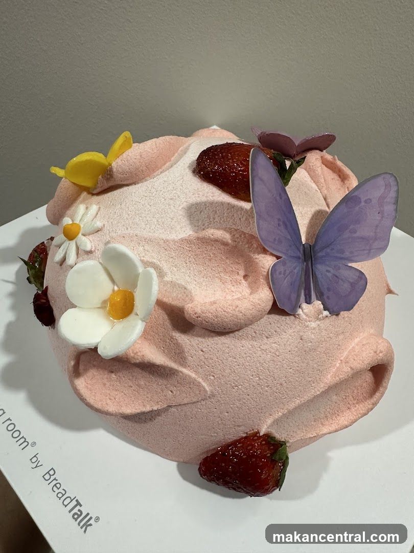 Pink Frosted Cake with Strawberries and Butterflies