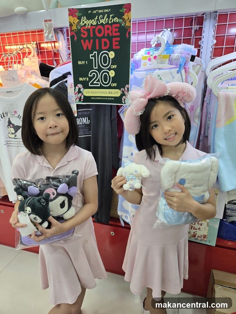 Two girls holding plush toys in a store