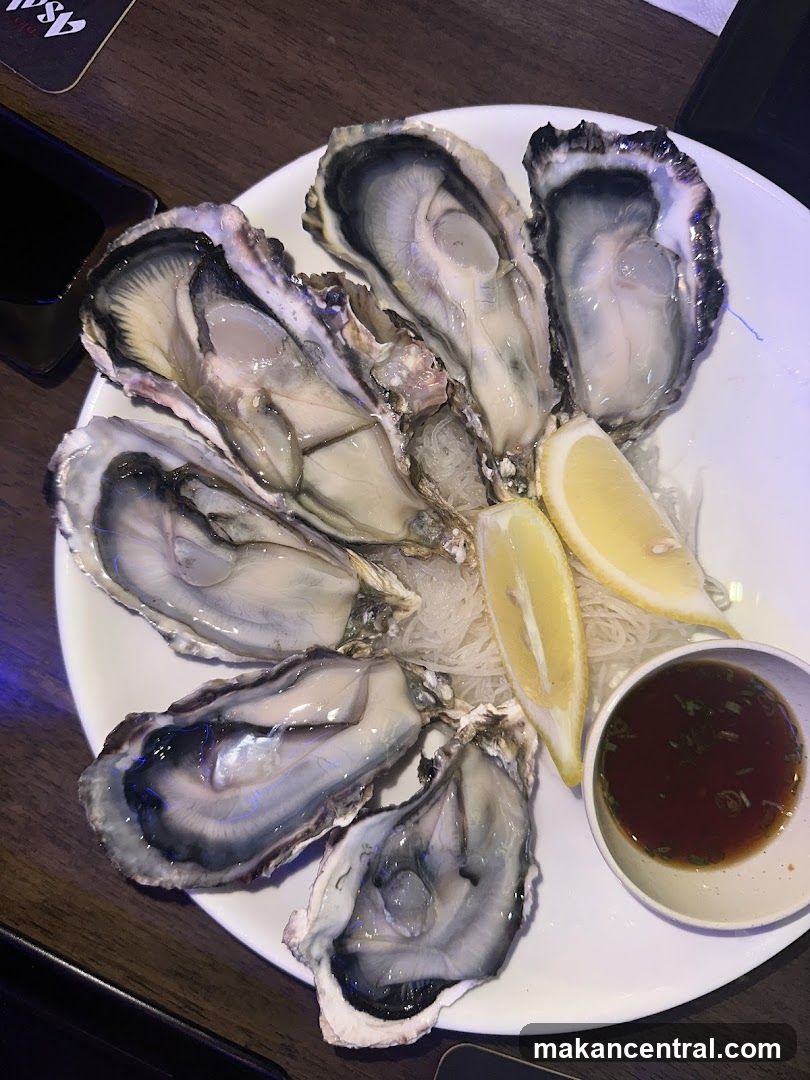 Oysters on ice with lemon and dipping sauce