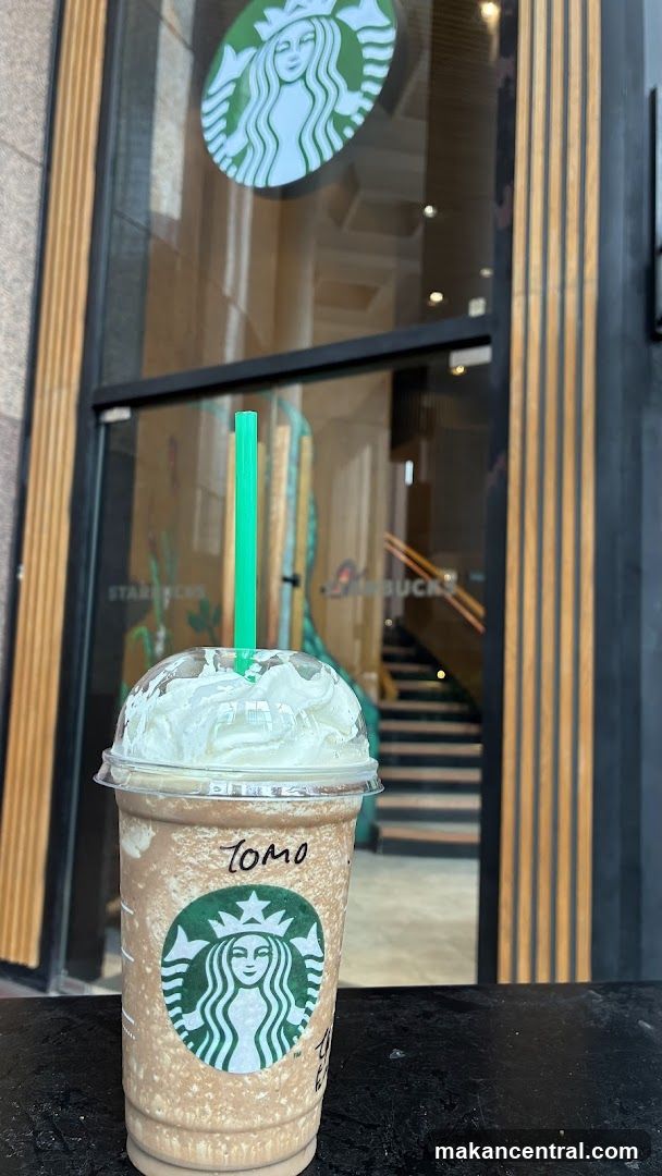 Starbucks drink in front of storefront