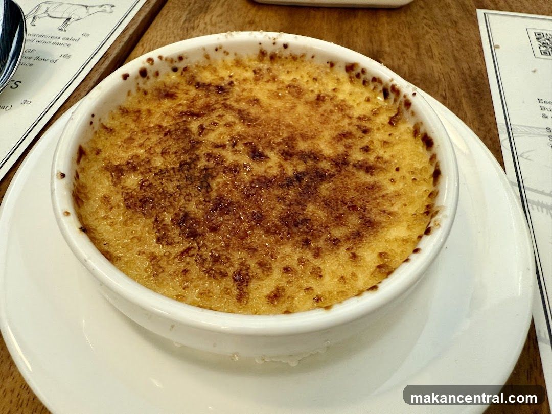 Creme Brulee in a white bowl on a wooden table