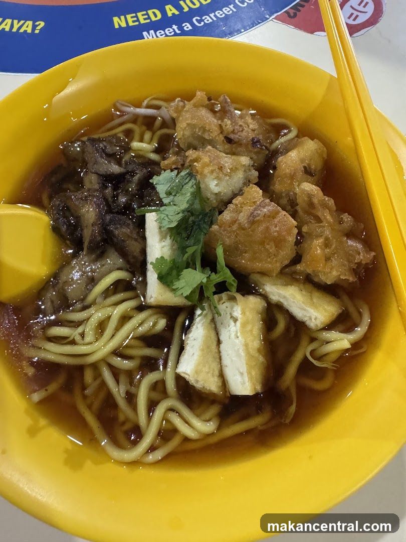 Noodles in yellow bowl with chopsticks