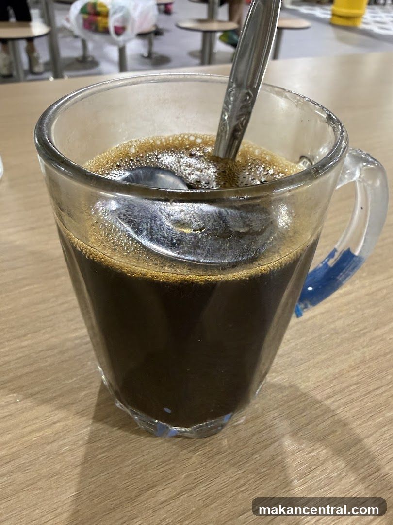 Coffee in glass mug with spoon