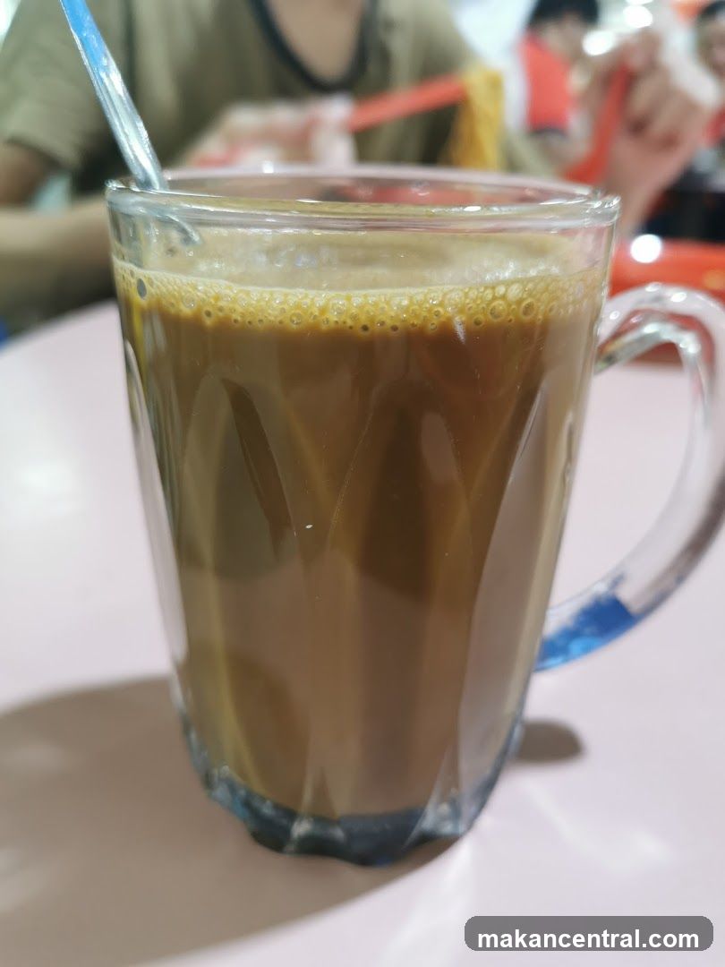 Cup of beverage in glass mug with straw